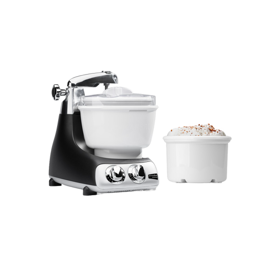 Black and silver ice cream mixer attachment with white freezing bowl and additional bowl filled with ice cream, designed as a specialty kitchen gadget for making frozen treats with ease.