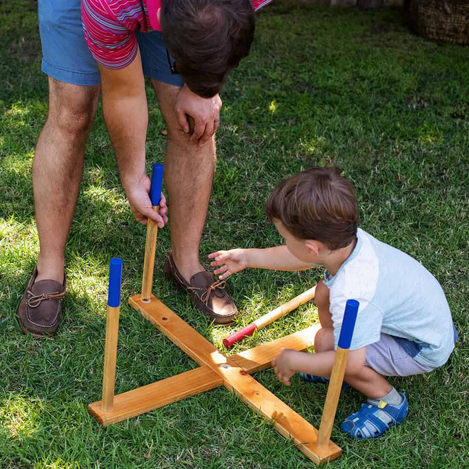 Child and adult playing oversized ring toss game with handcrafted wooden frame and colorful rings on green grass, part of Toys, Books & Games and Lawn Games collections