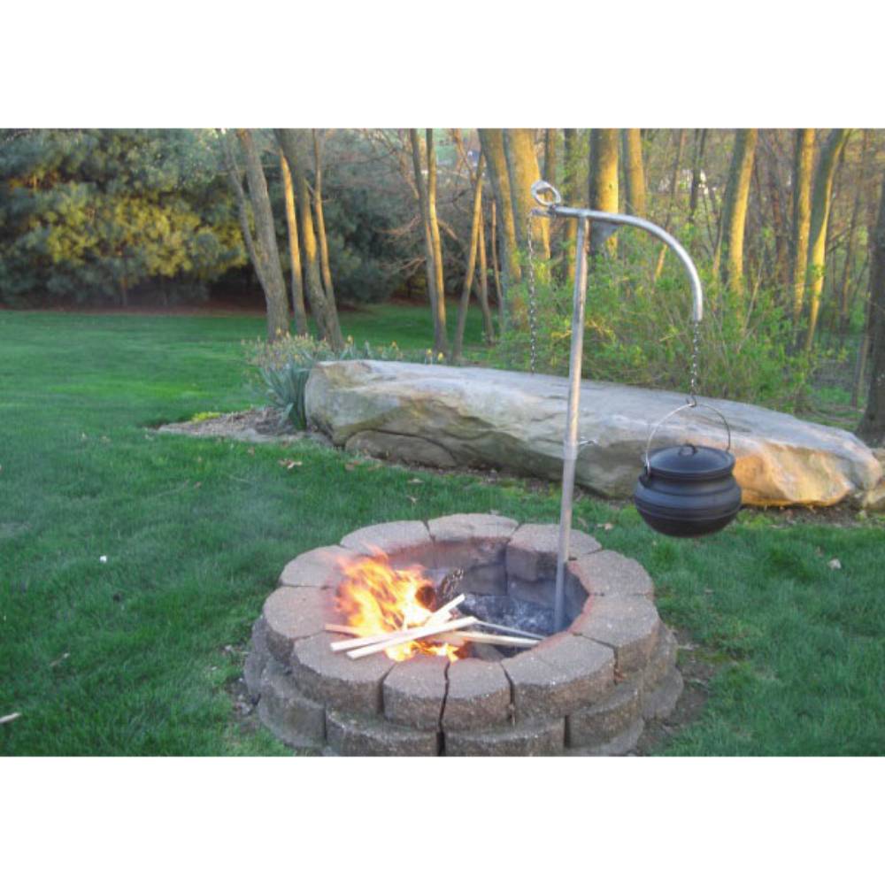 Outdoor fire pit with sturdy 36" support post and kettle hook holding a black cast iron pot over flames, showcasing durable, weather-resistant stainless steel grilling gear for Farm, Garden & Tool and Camping collections.