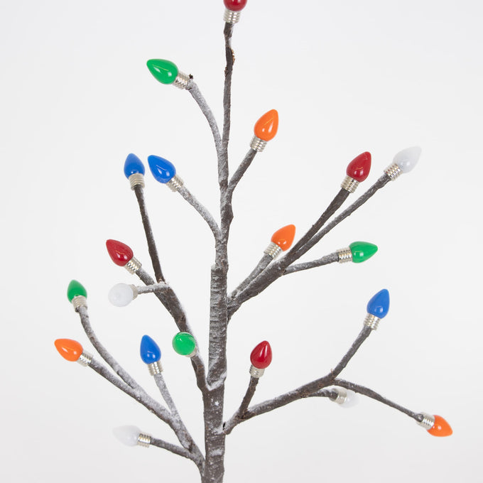 Close-up of handcrafted holiday tree branches dusted with snow, adorned with colorful bulb caps in red, blue, green, orange, and white, ideal for Home & Decor, Holiday Decor, Best Sellers, and Promo Eligible collections.