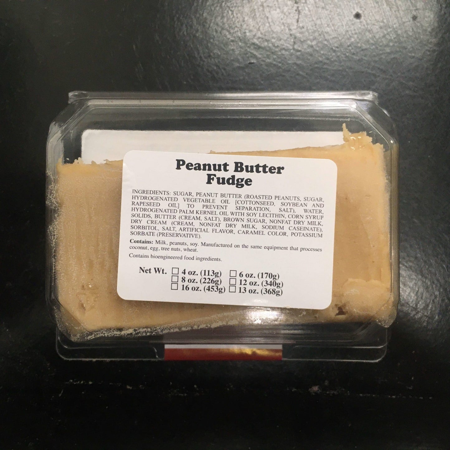 Clear plastic container with a generous portion of creamy peanut butter fudge, handcrafted for a melt-in-your-mouth texture, featured in Kitchen & Food, Snacks and Sweets, USA Made, Best Sellers, and Promo Eligible collections.