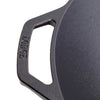 Close-up of a cast iron wok handle with embossed brand name, showcasing sturdy construction and seasoning, ideal for kitchen use in cookware and cast iron collections.