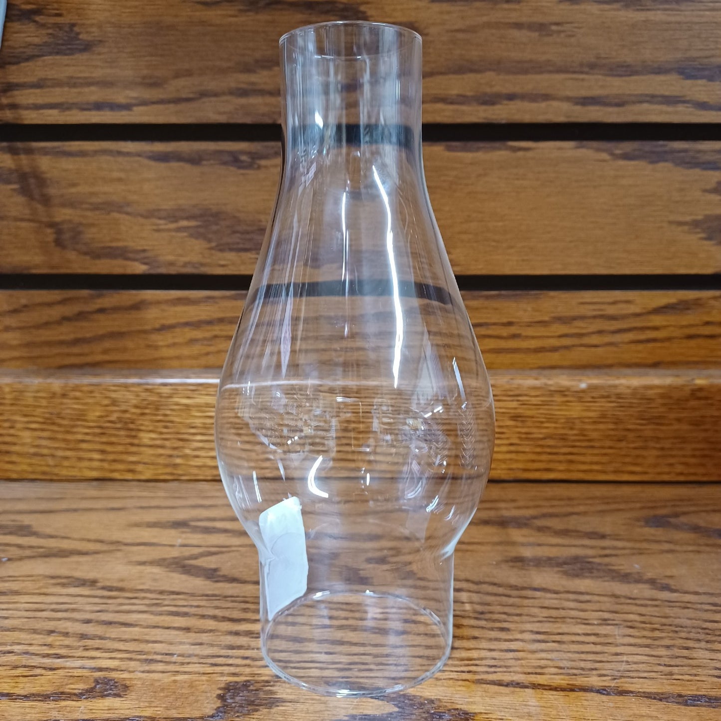 Clear vintage-style glass chimney with a shaped bulge for lamps, suitable for lamps and lighting, parts and accessories, and chimneys and globes collections.