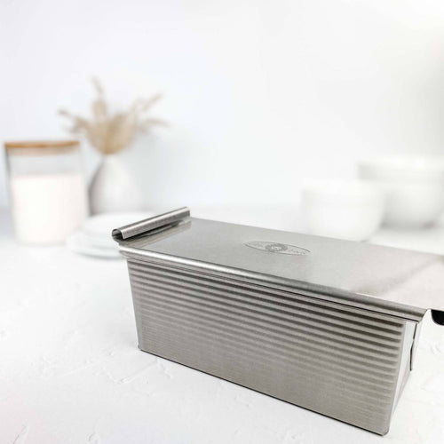 Heavy-duty aluminized steel bread loaf pan with lid, designed for even heat conduction and consistent baking results, ideal for kitchen baking supplies and cookware collections.