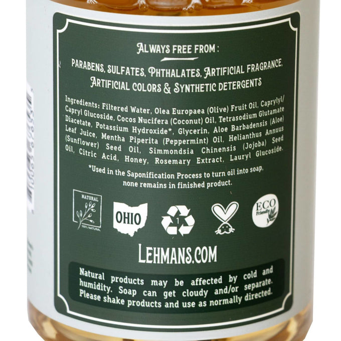 Close-up of the back label on a handcrafted soap bottle highlighting natural ingredients like olive, coconut, sunflower, jojoba oils, honey, and peppermint, free from synthetic additives, made in USA, ideal for Health & Wellness, Grooming and Personal Hygiene, and Soaps collections.
