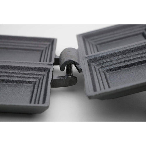 Close-up view of a handcrafted cast iron double pie iron hinge with an open design for easy cleaning, featured in Farm, Garden & Tool and Camping collections.