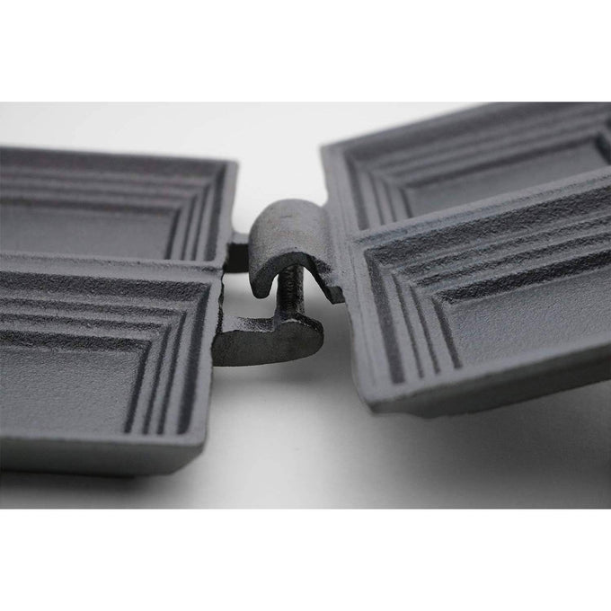 Close-up view of a handcrafted cast iron double pie iron hinge with an open design for easy cleaning, featured in Farm, Garden & Tool and Camping collections.