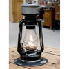 Handcrafted black powder-coated steel lantern with heat-resistant chimney and adjustable flame, designed for lighting, cooking, and heating in camping and emergency use.