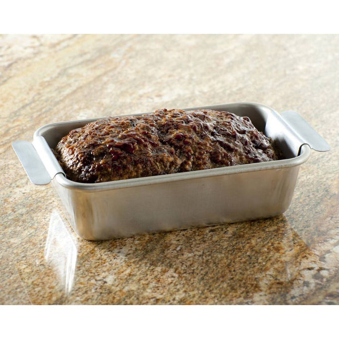 Roasted meatloaf resting in a rectangular aluminum pan with handles on a granite countertop, suited for Kitchen & Food, Cookware, and USA Made collections.