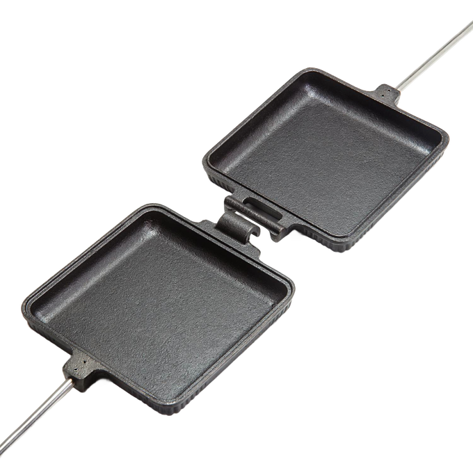 Open cast iron sandwich iron with hinged square pans and long handles, designed for toasting bread and bagels over a campfire, ideal for Farm, Garden & Tool, Camping, and Best Sellers collections.