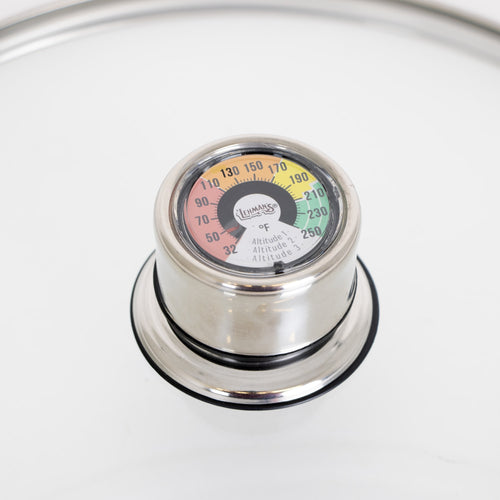 Close-up of a built-in temperature gauge on a stainless steel water bath canner lid, designed for precise heat control in food preservation, featured in Kitchen & Food and Canning collections.