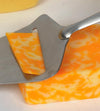 Stainless steel blade cheese slicer with wooden handle cutting a thin slice of marbled cheddar, ideal for Kitchen & Food, Specialty Equipment, and DIY Cheese collections.