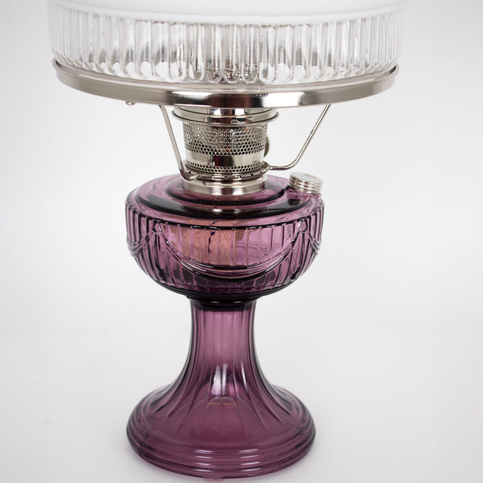 Handcrafted Amish-made oil lamp with a rich amethyst glass base and clear ribbed glass chimney, featuring a brass burner, ideal for Farm, Garden & Tool, Emergency Supplies, and Lamps & Lighting collections.