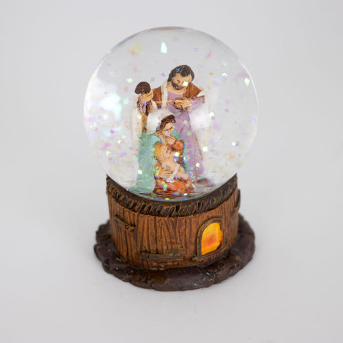 Handcrafted miniature glitter globe featuring a detailed Holy Family scene inside a glass dome with a rustic wood-textured base, perfect for Home & Decor and Holiday Decor.