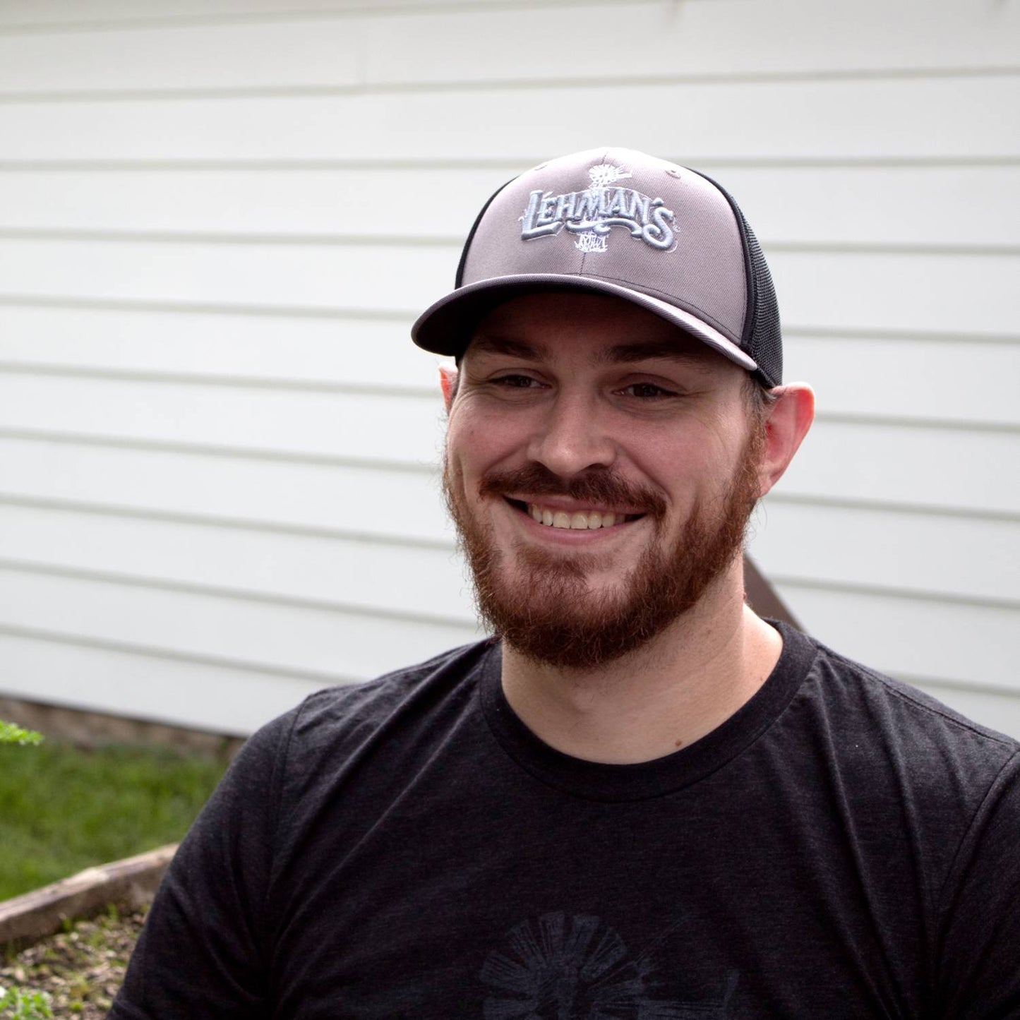 Man wearing a handcrafted embroidered trucker hat with stretch mesh back panels and a slight pre-curved visor, suited for Health & Wellness, Clothing and Accessories, and Best Sellers collections.