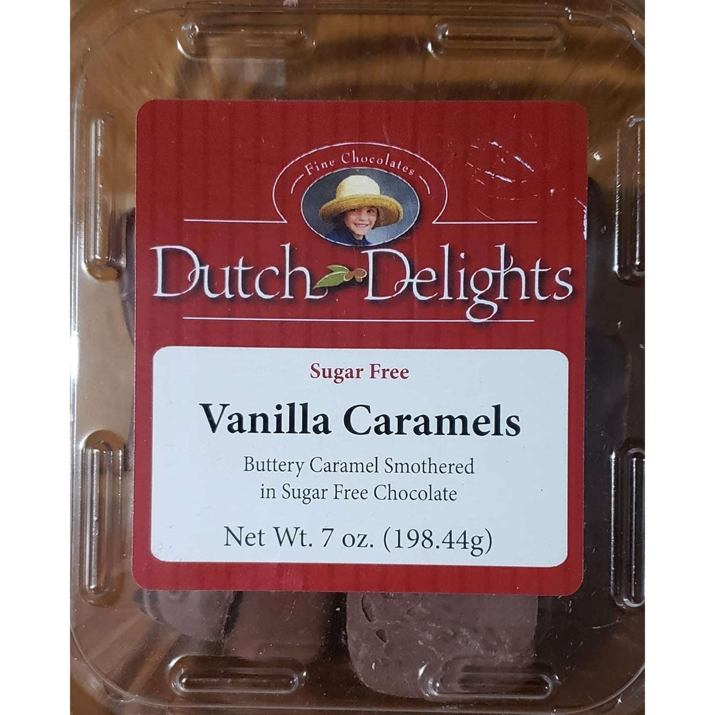 Clear plastic container of sugar-free vanilla caramels coated in sugar-free chocolate, handcrafted in the USA, featured in Kitchen & Food and Snacks and Sweets collections.