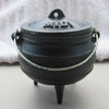 Small cast iron pot with three built-in legs and attached metal handle, seasoned with flaxseed oil, ideal for outdoor dining and kitchen use, in Kitchen & Food and Cast Iron collections.