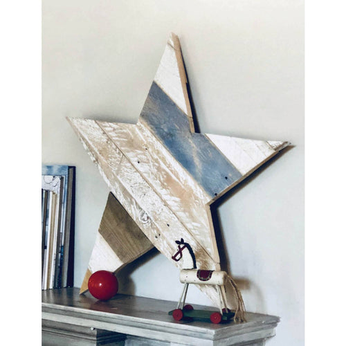 Handcrafted rustic wooden star decoration made from reclaimed pallet wood, displayed on a shelf with a vintage toy horse, ideal for Home and Garden How-To Books and Toys, Books & Games collections.