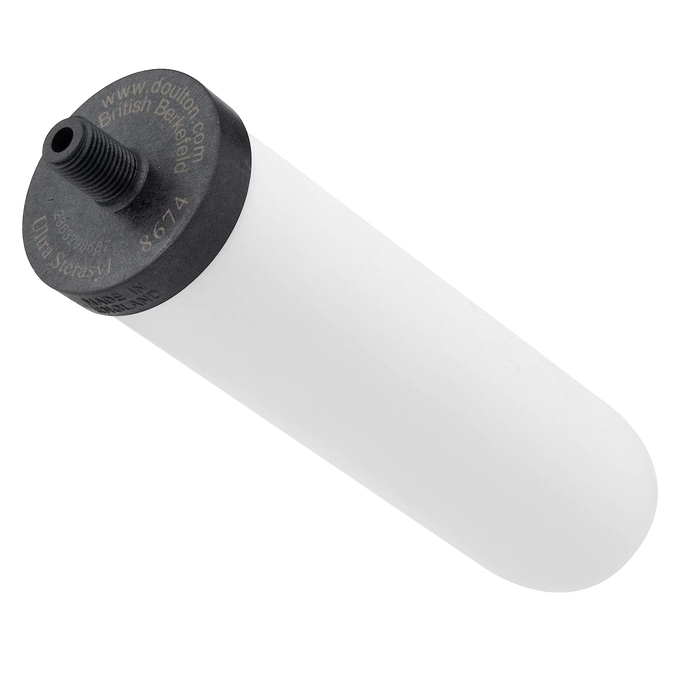 Handcrafted white ceramic water filter cartridge with black threaded top featuring granular activated carbon, compatible with British Berkefeld gravity systems, ideal for emergency supplies and farm use.