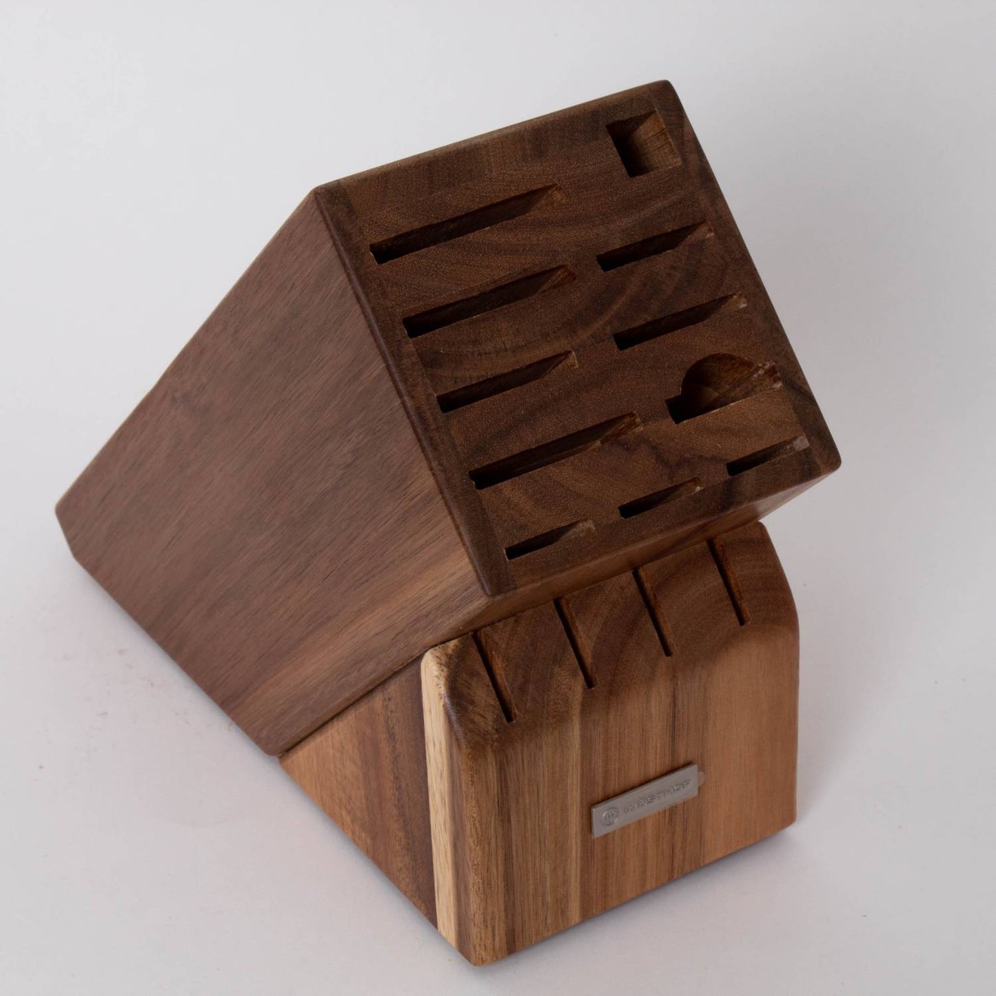 Angled wooden knife block made from rich-toned wood with multiple slots for storing a variety of kitchen knives and a sharpening tool, suited for Kitchen & Food and Knives & Axes collections.