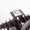 Close-up of a black heat-activated oscillating stove fan with curved finned blades and a warning label, designed to improve warm air circulation in stoves and hearth accessories collections.