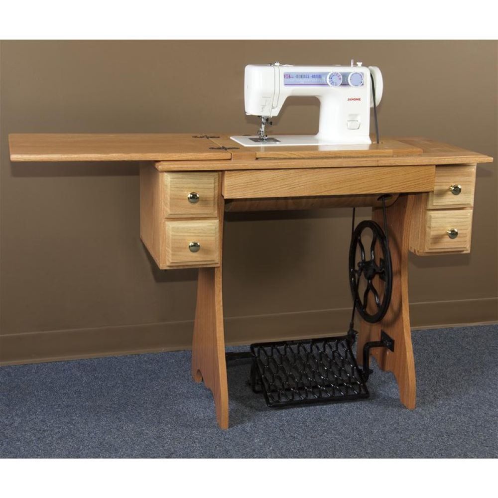 Traditional sewing machine set in a handcrafted wooden cabinet with drawers and a foot-powered treadle, perfect for Home & Decor and Sewing and Quilting collections.