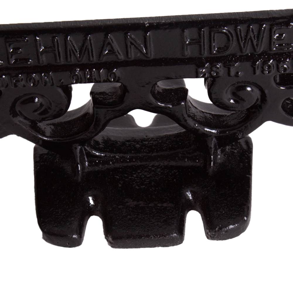 Close-up of a glossy black cast aluminum boot scraper with vintage scroll detailing, handcrafted by Amish makers, ideal for Home & Decor and Household Helpers collections.