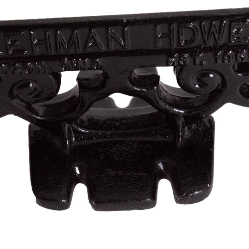 Close-up of a glossy black cast aluminum boot scraper with vintage scroll detailing, handcrafted by Amish makers, ideal for Home & Decor and Household Helpers collections.
