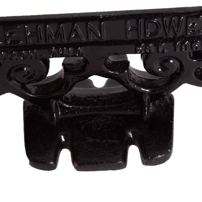 Close-up of a glossy black cast aluminum boot scraper with vintage scroll detailing, handcrafted by Amish makers, ideal for Home & Decor and Household Helpers collections.