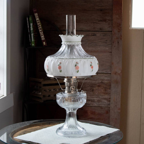 Clear glass oil lamp featuring a handcrafted 10-inch glass shade with delicate pink wildflower designs, softly diffusing light, ideal for Lamps & Lighting, Parts and Accessories, and Lamp Shades collections.