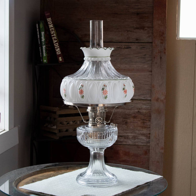 Clear glass oil lamp featuring a handcrafted 10-inch glass shade with delicate pink wildflower designs, softly diffusing light, ideal for Lamps & Lighting, Parts and Accessories, and Lamp Shades collections.