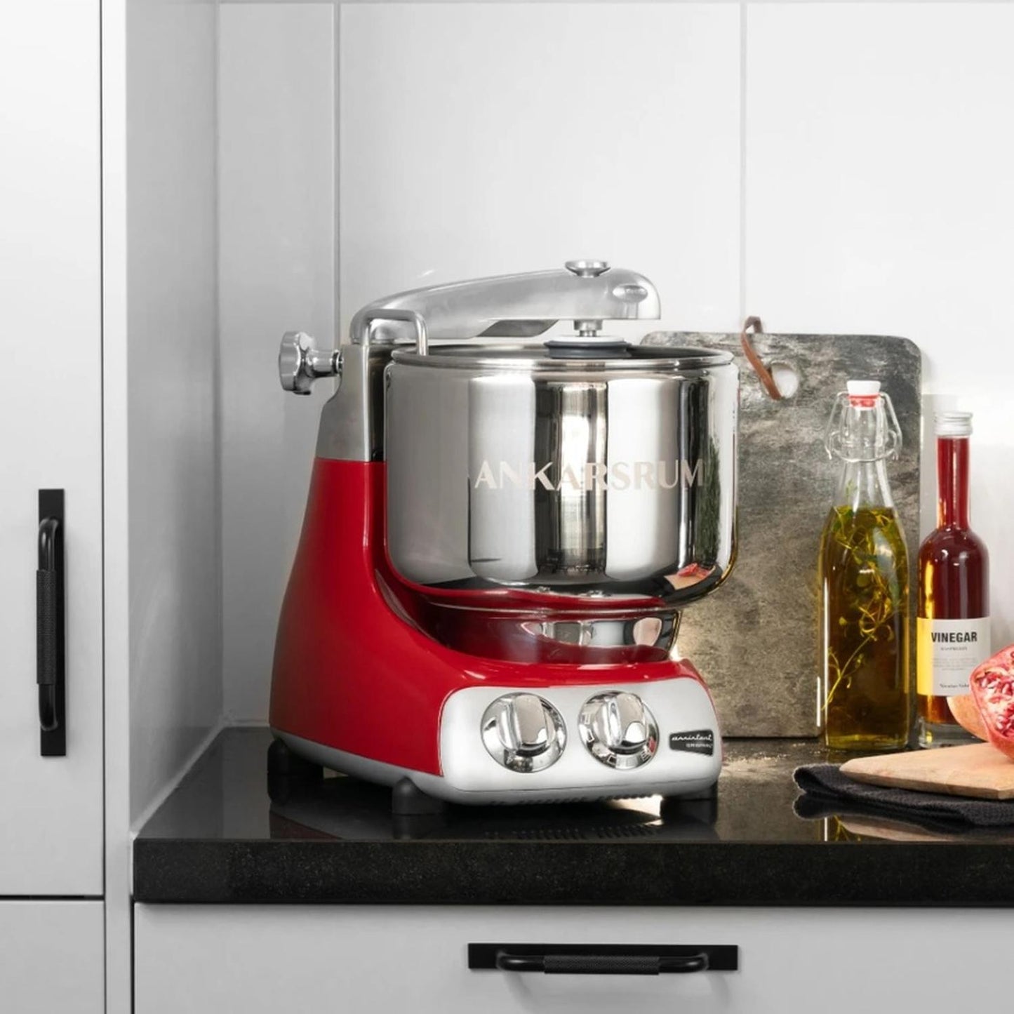 Handcrafted red and polished stainless steel stand mixer with dual control knobs, displayed on a kitchen counter with olive oil and vinegar bottles, ideal for Baking Supplies and Kitchen Gadgets collections.