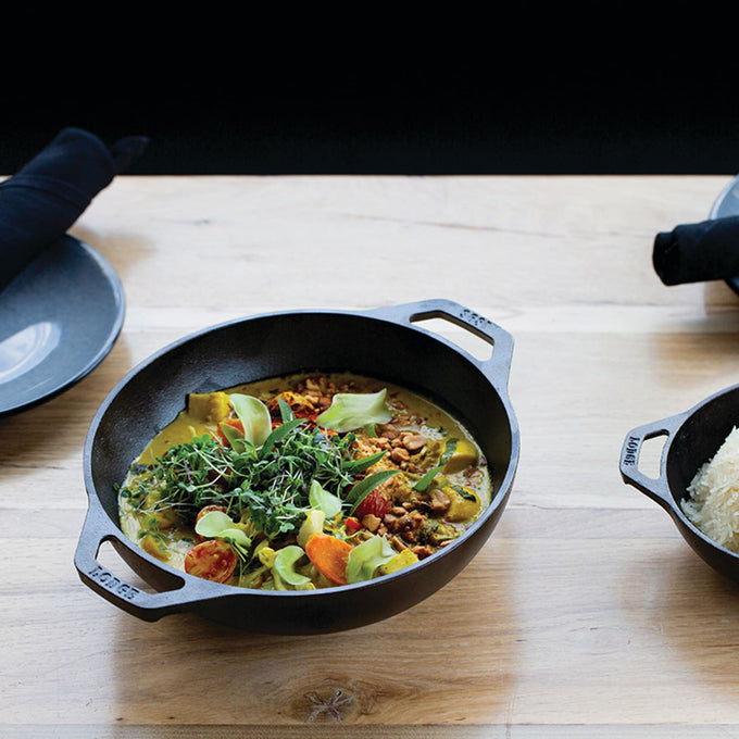 Handcrafted cast iron mini wok with flat bottom and loop handles, filled with a colorful stir-fry dish, featured in Kitchen & Food, Cookware, Cast Iron, Pots and Pans, USA Made, and Best Sellers collections.