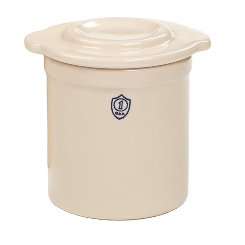 Cream-colored stoneware crock lid with raised center, handcrafted in the USA, designed for food preservation and fermenting in kitchen and pickling collections.