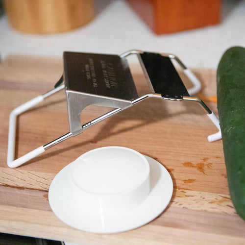 Handcrafted vegetable slicer with stainless steel blade and white frame, designed for uniform cuts between 1/8" to 1/2" thick, ideal for Kitchen & Food, Food Prep, Choppers and Cutters, Best Sellers, and Promo Eligible collections.