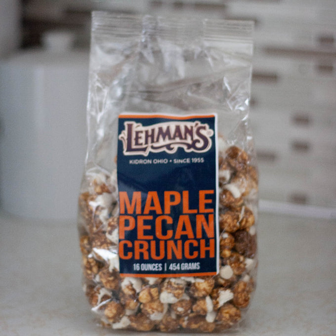 Clear bag of handcrafted maple pecan caramel popcorn crunch, a rich and sweet snack made in USA, featured in Kitchen & Food, Snacks and Sweets, Popcorn, USA Made, and Best Sellers collections.