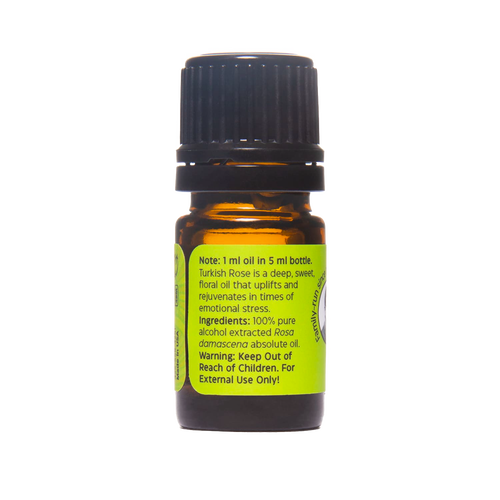 Small amber glass bottle with black screw cap, featuring a bright green label describing pure Turkish Rose absolute oil, handcrafted and made in USA, included in Health & Wellness and Best Sellers collections.