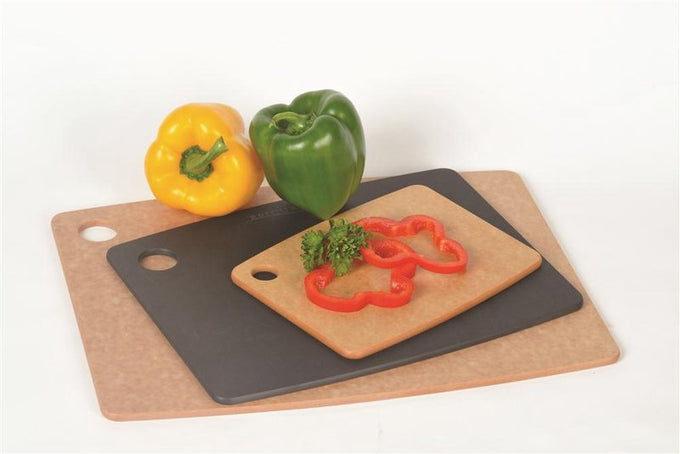 Set of three lightweight Epicurean cutting boards in natural and black pressed paper with utility holes, shown with fresh bell peppers, ideal for Kitchen & Food and Food Prep collections.