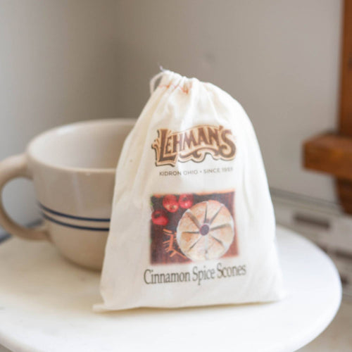 Cotton drawstring pouch containing handcrafted Lehman's cinnamon spice scone mix, presented near a ceramic cup, ideal for Kitchen & Food, Pantry, Dry Goods and Mixes, Best Sellers, Promo Eligible collections.