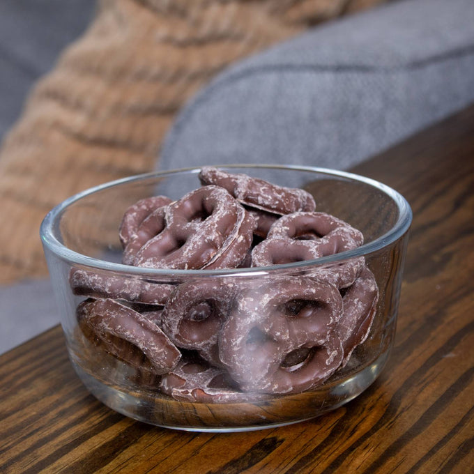 Clear glass bowl filled with handcrafted Amish-made chocolate covered pretzels in milk chocolate, a USA made snack ideal for Kitchen & Food, Snacks and Sweets, Candy, Best Sellers, and Promo Eligible collections.