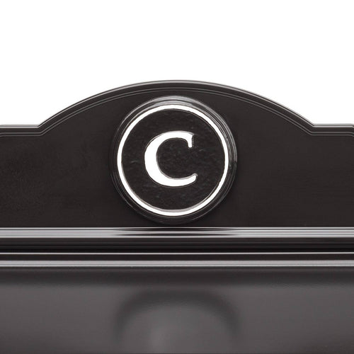 Close-up of a handcrafted black and white custom wall mount mailbox featuring a raised circular monogram letter "C," designed to enhance curb appeal in Home & Decor and USA Made collections.