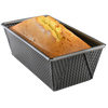 Non-stick heavy gauge steel loaf pan with corrugated sides and folded corners, holding a freshly baked golden bread loaf, ideal for Kitchen & Food, Baking Supplies, and Best Sellers collections.