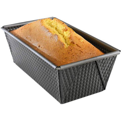 Non-stick heavy gauge steel loaf pan with corrugated sides and folded corners, holding a freshly baked golden bread loaf, ideal for Kitchen & Food, Baking Supplies, and Best Sellers collections.