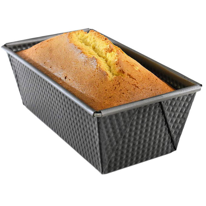 Non-stick heavy gauge steel loaf pan with corrugated sides and folded corners, holding a freshly baked golden bread loaf, ideal for Kitchen & Food, Baking Supplies, and Best Sellers collections.