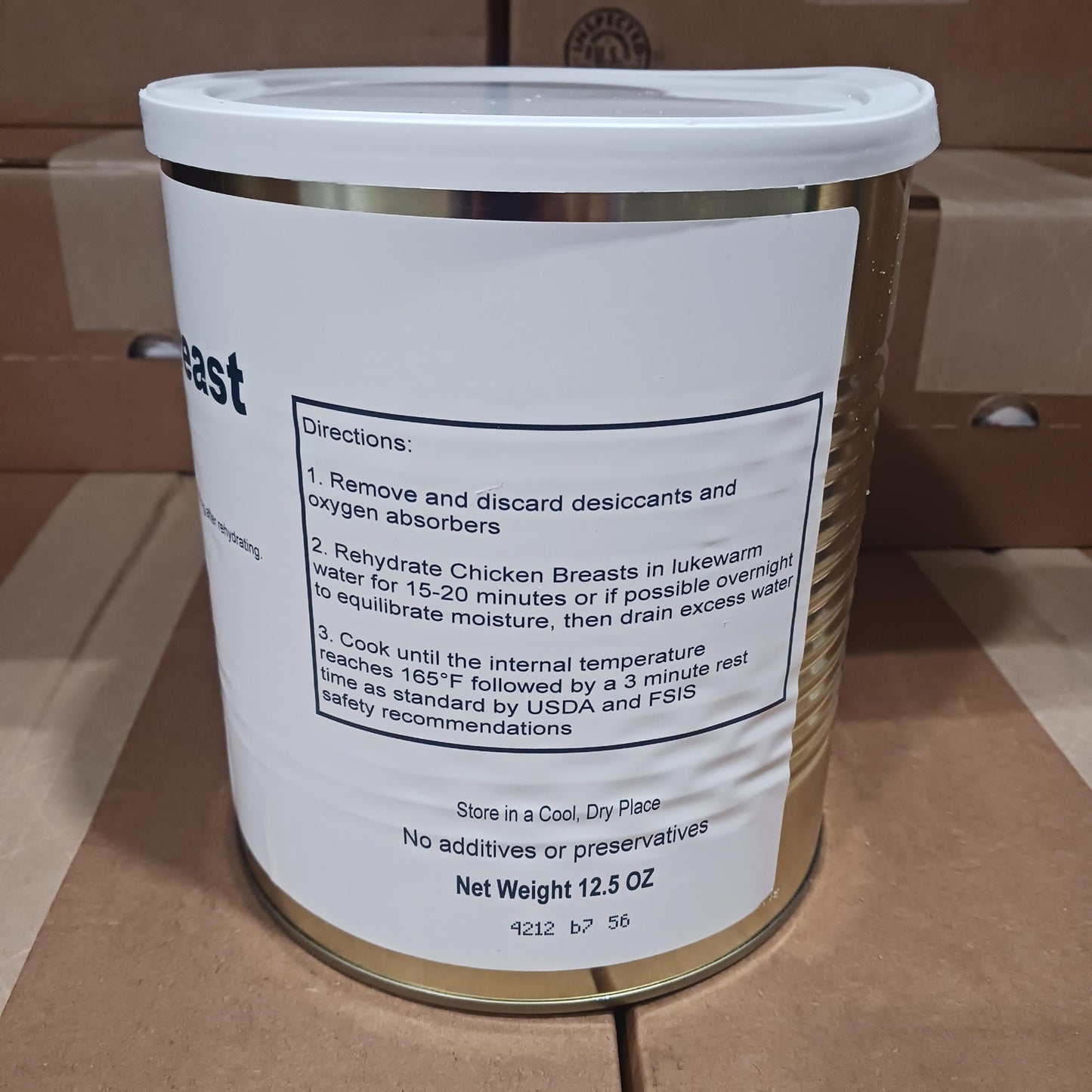 Metal container of handcrafted freeze-dried chicken breasts with detailed rehydration instructions, made in USA for emergency supplies and kitchen food collections.