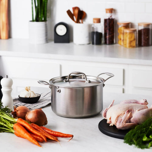 Handmade stainless steel 5-quart sauce pot with lid, featuring durable fully clad construction, displayed on a kitchen countertop with fresh vegetables and poultry, ideal for Kitchen & Food, Cookware, Pots and Pans, and Best Sellers collections.