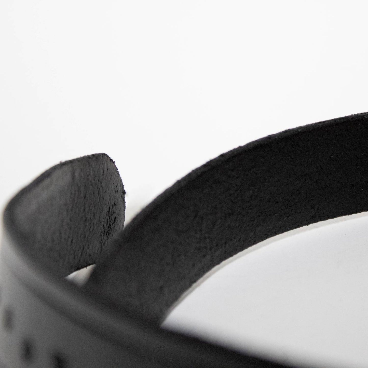 Close-up of the smooth black genuine cowhide leather strap, part of a handcrafted Amish-made belt from USA Made and Clothing and Accessories collections, ideal for casual or work wear.