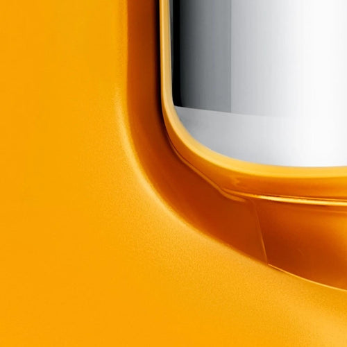 Close-up of a handcrafted bright orange stand mixer base with smooth curves and a polished stainless steel bowl edge, perfect for Kitchen & Food, Baking Supplies, and Cooking and Baking Helpers collections.
