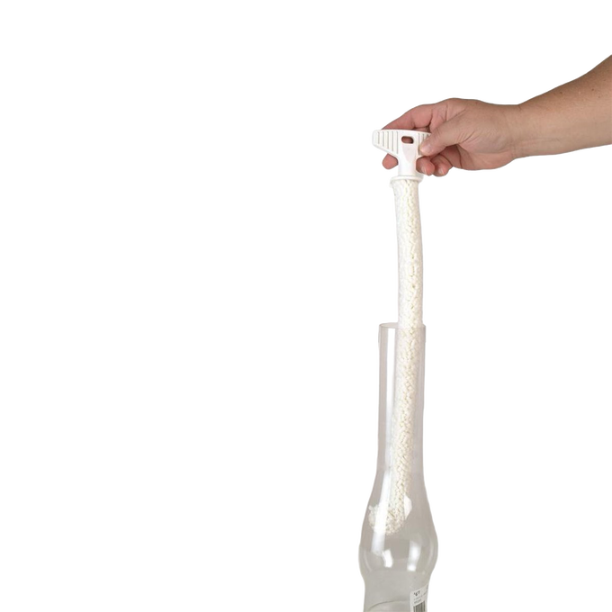 Hand holding a flexible white foam brush with a textured surface inserted into a glass chimney, designed for thorough cleaning, USA made and ideal for lamps and lighting maintenance.
