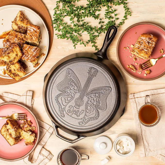 12-inch cast iron skillet with embossed butterfly and guitar design featuring "Dolly" lettering, handcrafted in the USA, perfect for Kitchen & Food, Cast Iron, Cookware, USA Made, and Best Sellers collections.